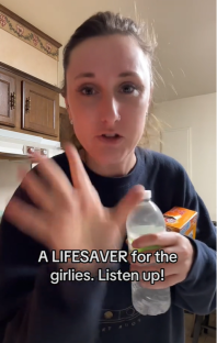 Woman holding water and Alka-Seltzer, suggesting a remedy.