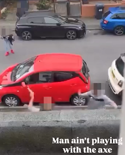 Shocking moment maniac armed with axe chases man down the street in broad daylight as horrified residents watch on