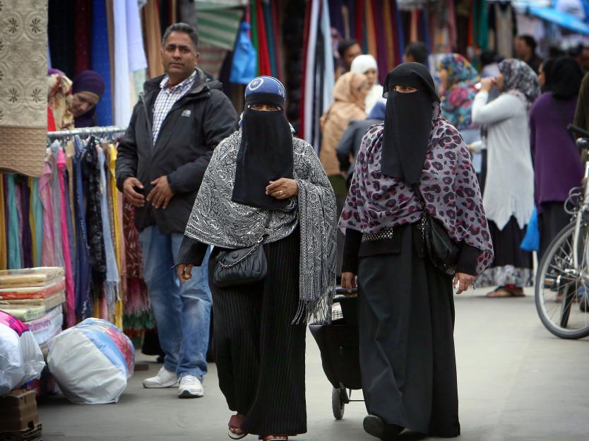 General view of Muslim women wearing traditional burkas or niqabs pictured in Whitechapel, East London.