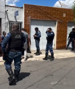 Police officers outside a house.