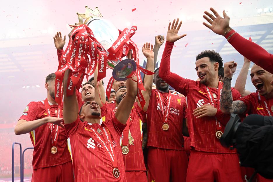 Liverpool F.C. players celebrating with the Premier League trophy.