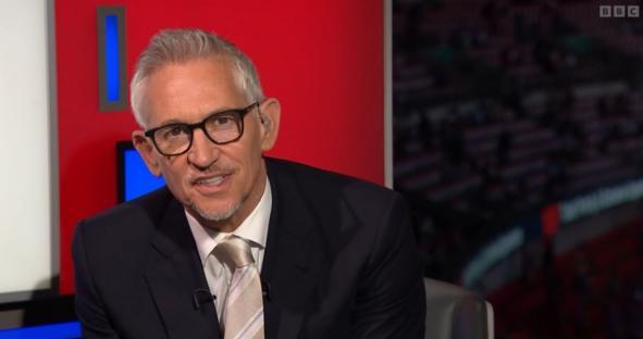 Gary Lineker in a suit and glasses.