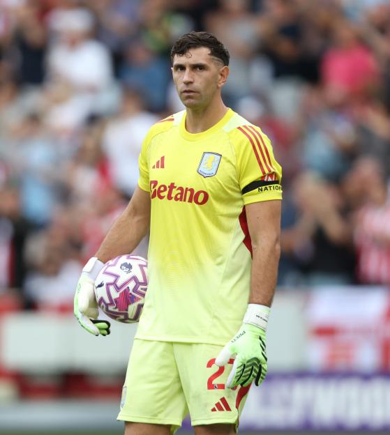 Emiliano Martínez, Aston Villa goalkeeper, holding a soccer ball.