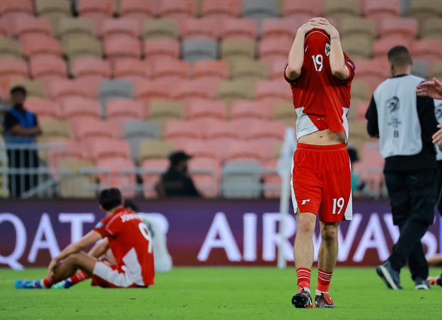 Indonesia's Thom Haye and Miliano Jonathans looking dejected after a soccer match.