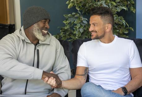 Peter Andre and Fredi Nwaka shaking hands.