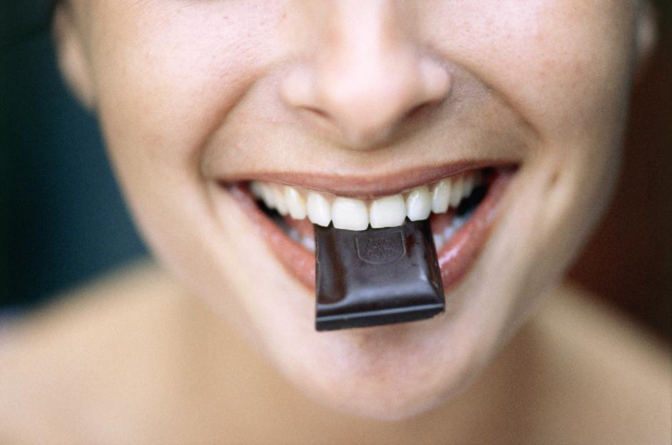 Young Woman Eating Chocolate