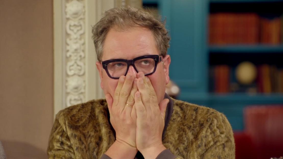 Jonathan Ross covering his mouth, appearing surprised or shocked.