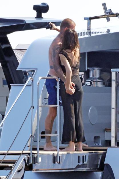 David and Victoria Beckham embracing on a yacht.