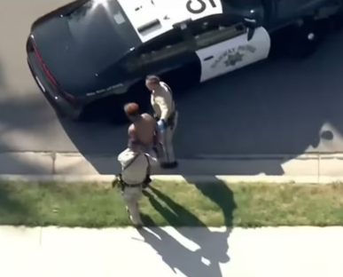 Police officers arresting a suspect.