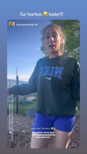 Woman in Nike sweatshirt speaking to camera.