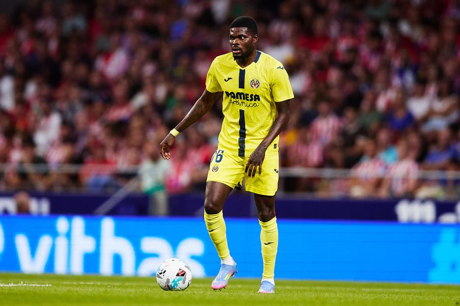Thomas Partey of Villarreal CF running with the ball during a soccer match.