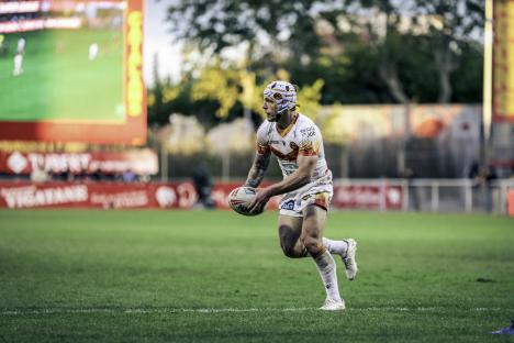 Rugby player running with the ball.