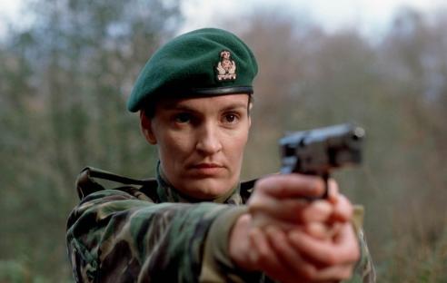 Still from the television series *Rough Treatment*, showing Daniela Nardini aiming a handgun.