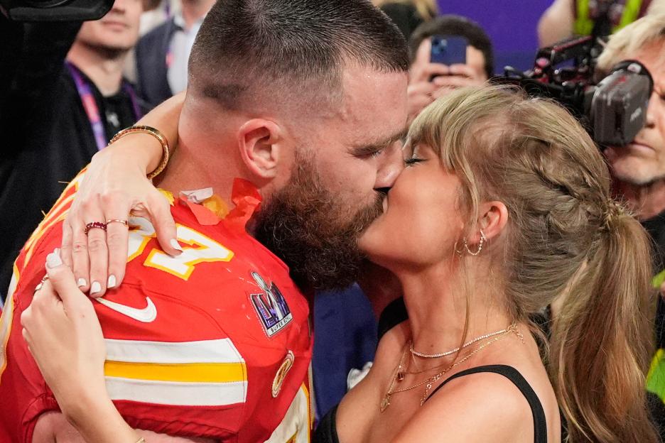 Taylor Swift kissing Travis Kelce after the Super Bowl.