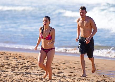 Phillipa Northeast and Alec Snow filming Home and Away on a beach.