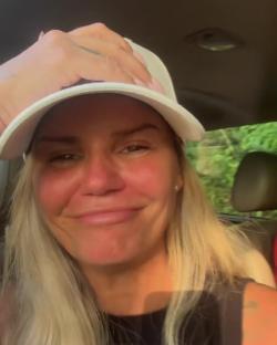 Kerry Katona crying in a car.