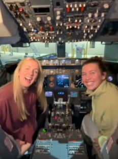 Two women smiling in the cockpit of a Southwest Airlines plane.