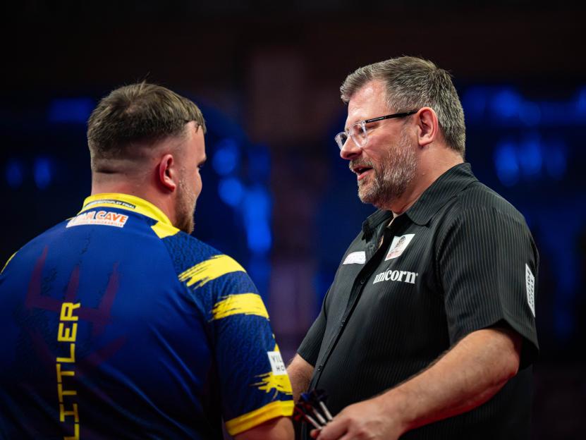 James Wade congratulating Luke Littler after a darts match.