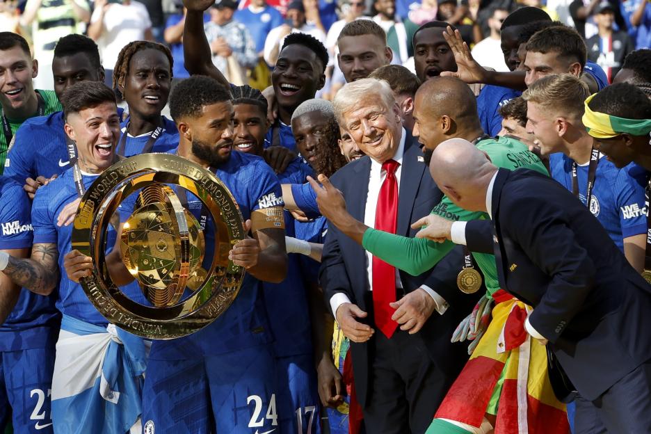 Donald Trump with the Chelsea football team celebrating a trophy win.