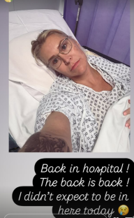 Woman in hospital gown in hospital bed.