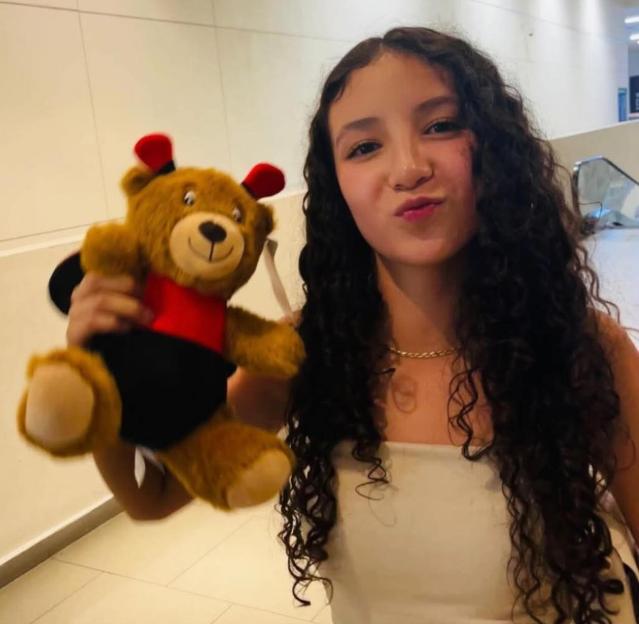 Paloma Nicole Arellano Escobedo holding a teddy bear.