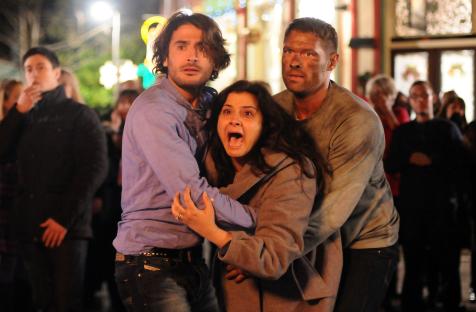 Scene from EastEnders showing three actors in a tense moment.