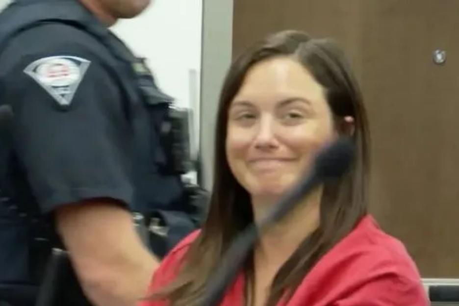 Sick ex- school teacher, 33, accused of molesting a student, 14, grins as she is released on bail after bombshell twist