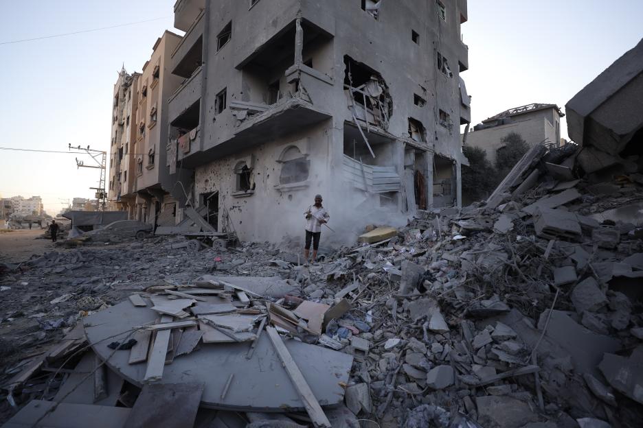 Palestinians surveying the damage to their homes after an Israeli attack.
