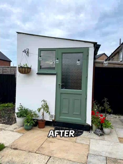 After photo of a garden shed with a painted green door and plants.