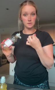 Woman holding a bottle of Tesco fruit drink, warning about choking hazard.