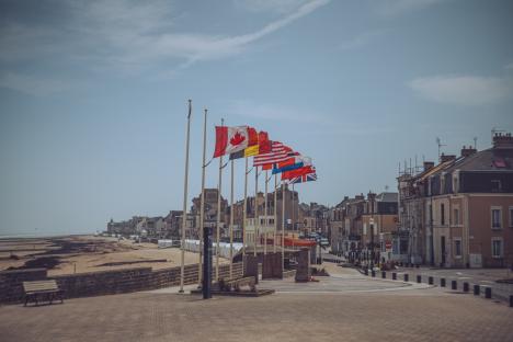 Allied flags fly on the Juno Beach seafront in Normandy.