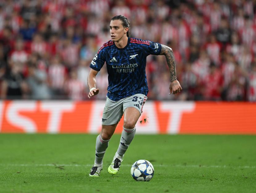 Riccardo Calafiori playing for Arsenal FC with a football during a match.