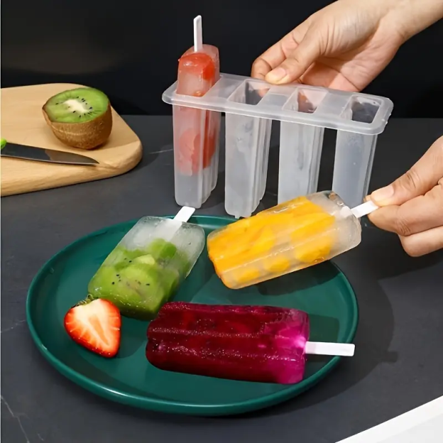 Ice pop molds with frozen fruit popsicles.