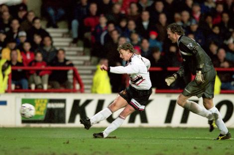 Ole Gunnar Solskjaer scoring a goal for Manchester United.