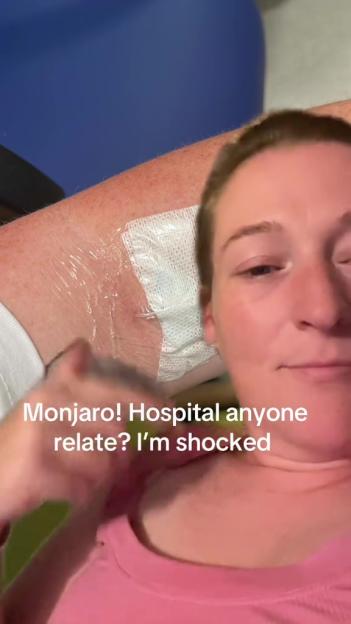 Woman in hospital with bandage on arm.