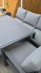 Grey outdoor furniture set with a slatted table.