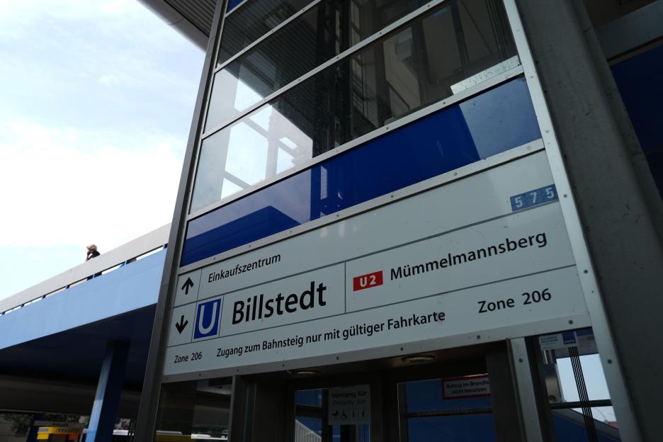 View of an elevator and signs at Billstedt subway station.