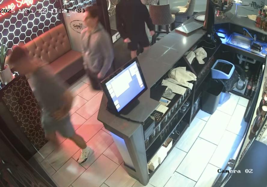 Surveillance footage of two people leaving a restaurant without paying.