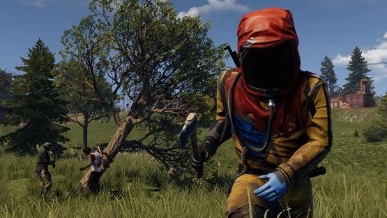 Screenshot of a video game showing a player in a hazmat suit holding an axe, with other players chopping down a tree in the background.