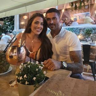 Couple sitting at a restaurant table.