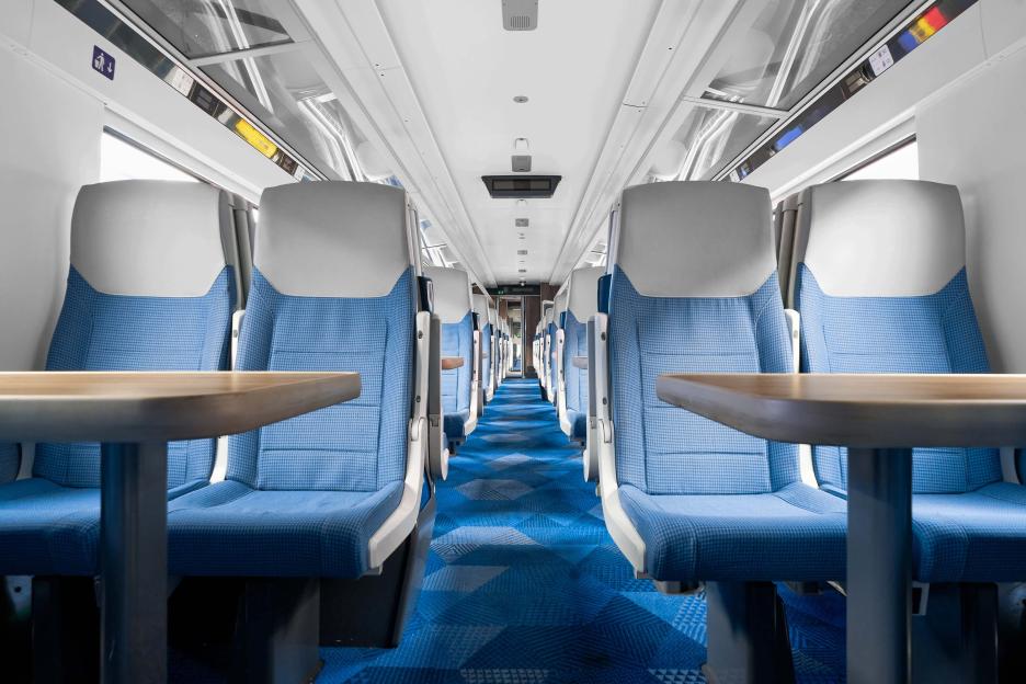 Power outlet and USB port on a train seat.