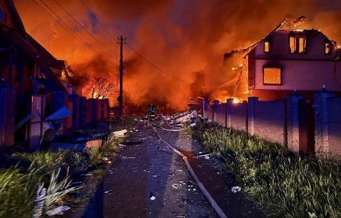 Firefighters battling a fire in a residential area after a Russian strike in Kyiv.