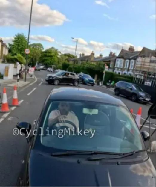 Person driving a car on a residential street.