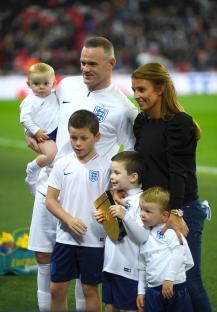 Wayne Rooney, his wife Coleen, and their four sons at a soccer match.