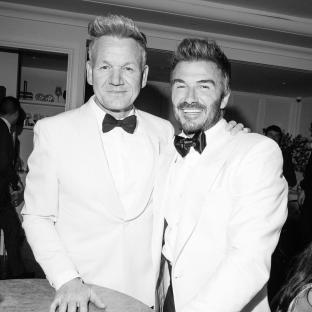 Black and white photo of Gordon Ramsay and David Beckham at a party.