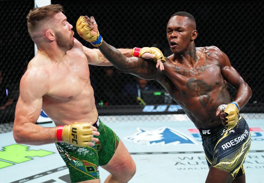 Israel Adesanya of Nigeria punches Dricus Du Plessis of South Africa during a UFC middleweight championship fight.