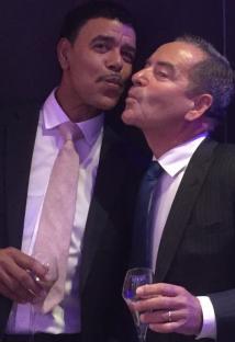 Jeff Stelling and Chris Kamara, holding champagne glasses.