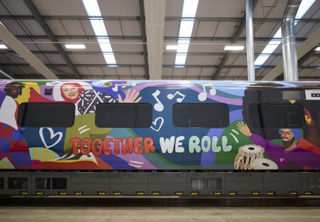 Train wrapped in artwork celebrating employees and communities.