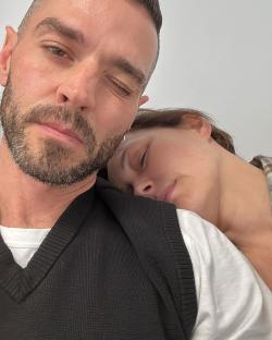 Close-up photo of a man and woman cuddling.