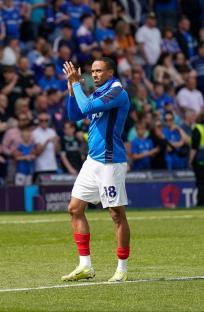 Soccer player Cohen Bramall applauding in front of a crowd.